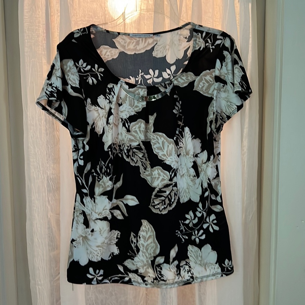 Short sleeve silky blouse size medium with light metal necklace accent.